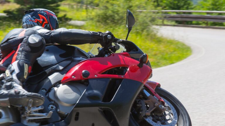 Motorcycle on display outdoors with rider in background, illustrating which social platform is best for your brand